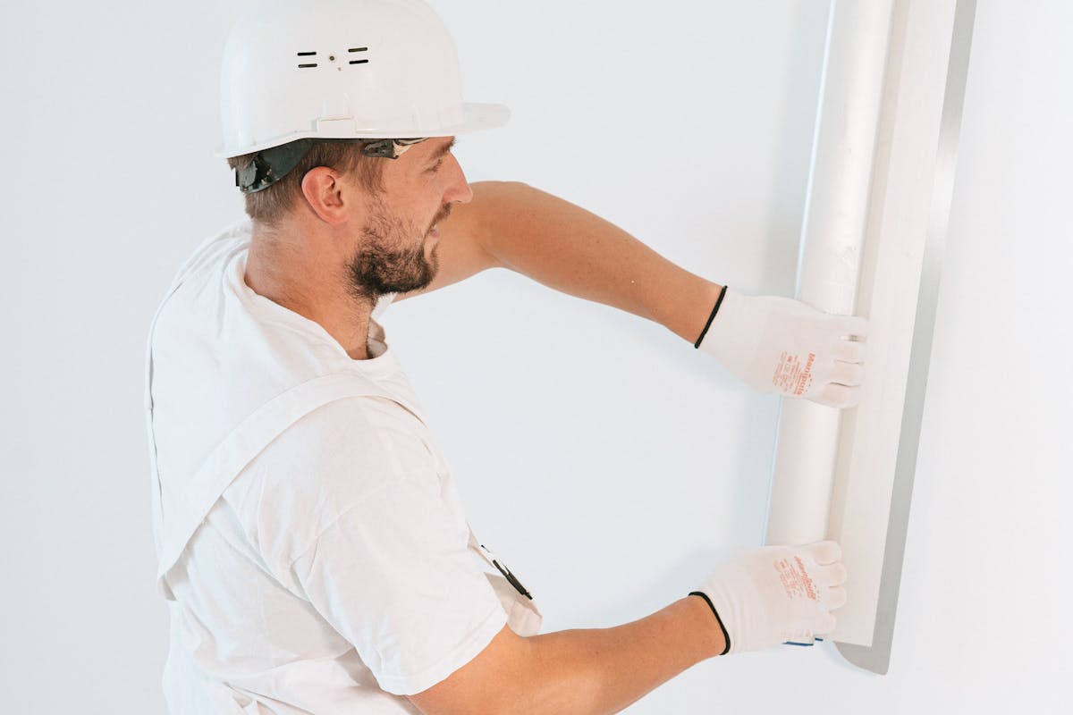 A Man Fixing the Wall