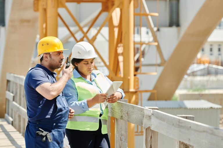 A Man in Blue Shirt Using a Walkie Talkie while Standing Beside the Woman