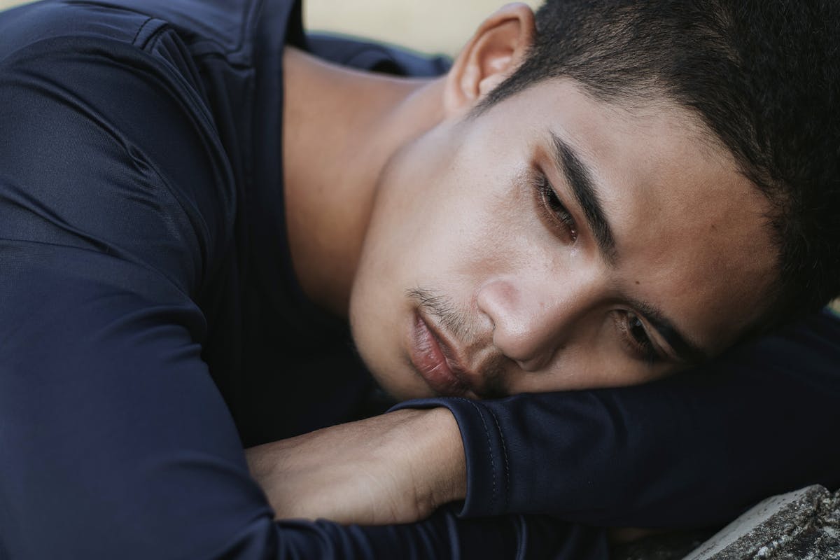 An Emotional Man Leaning on His Arms
