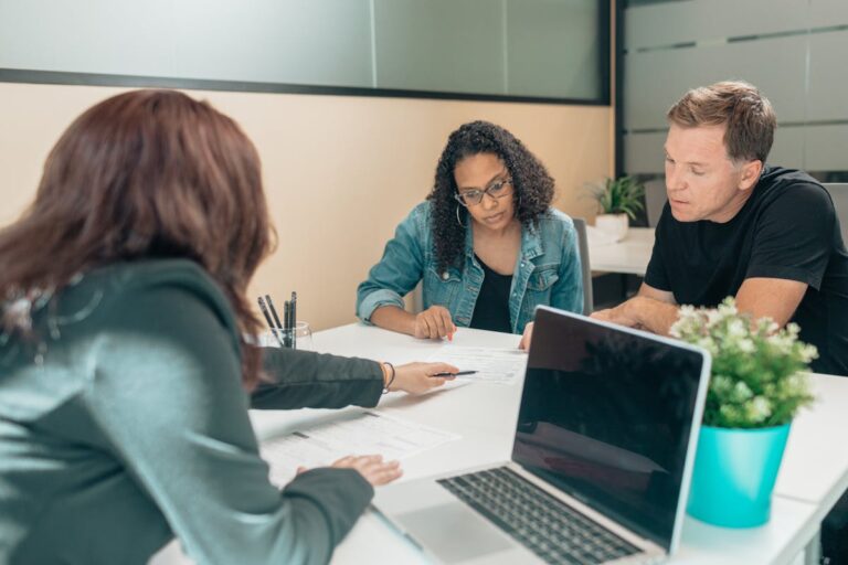 Couple meeting with advisor for adoption process in a modern office