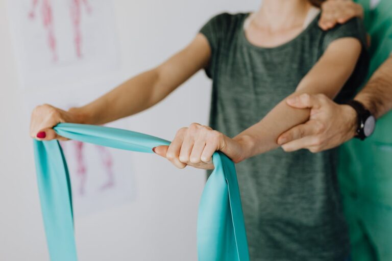 Crop anonymous woman stretching elastic band