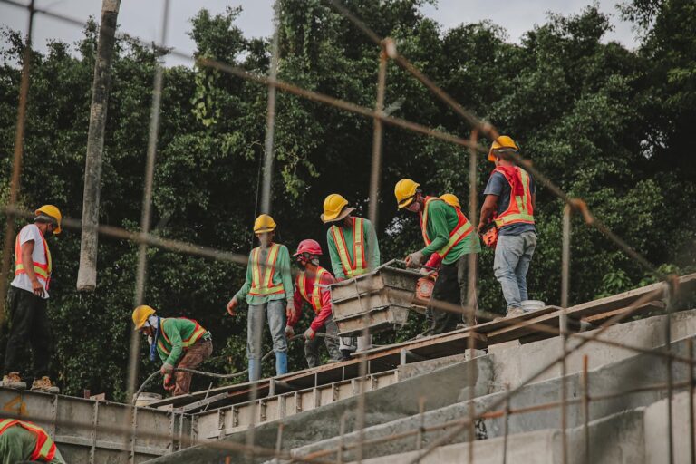 Group of People Wearing Hard Hats Standing on a Roof