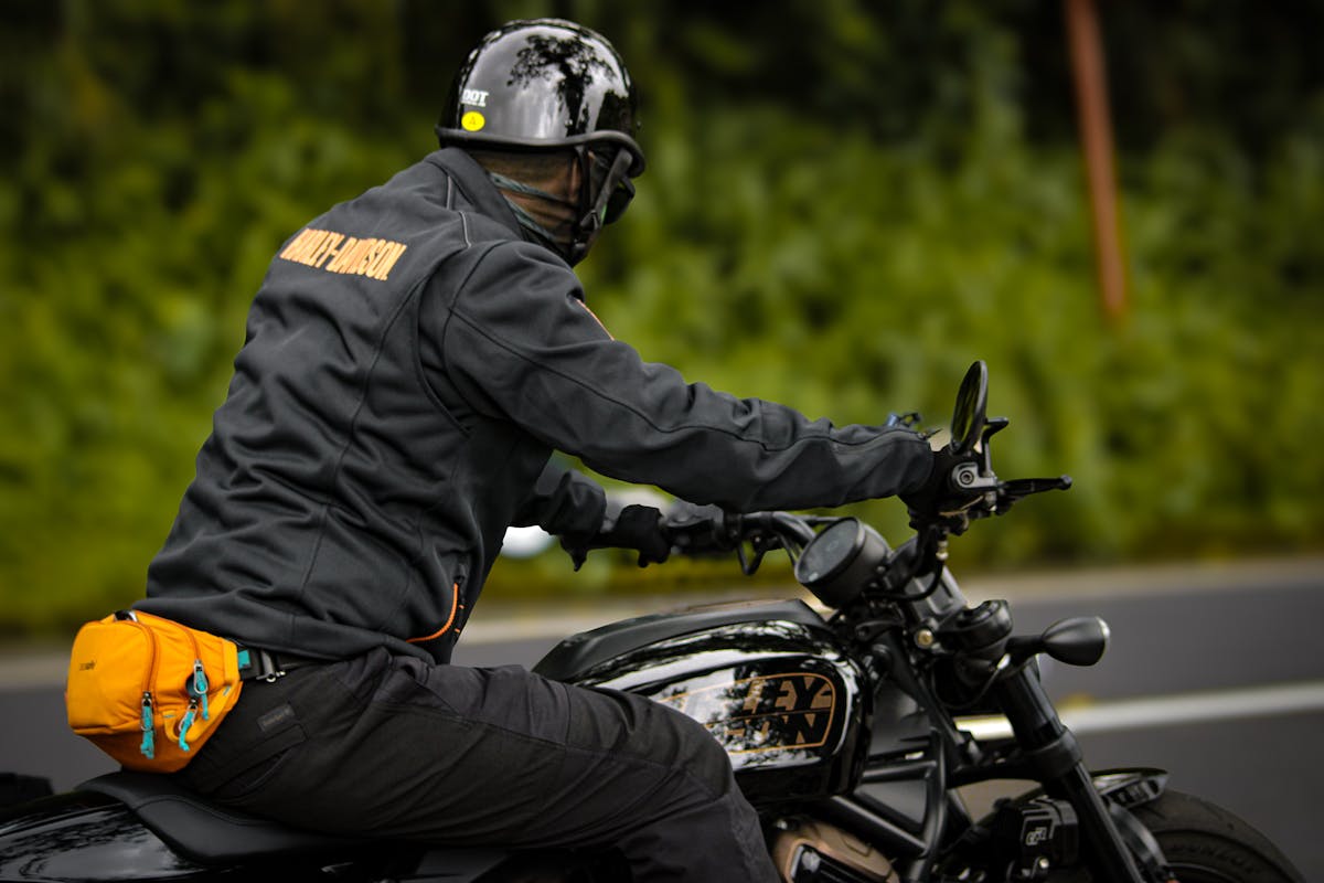 Man Riding Motorcycle on Road