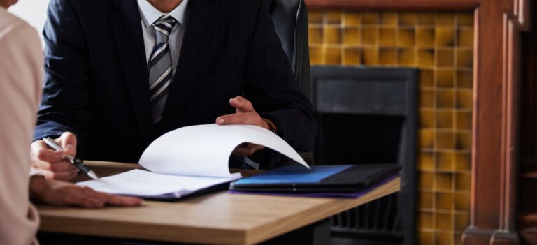 Contract, signing and lawyer consulting a client in his office with legal paperwork or agreement. Signature, approval and businessman in discussion with a woman with a document to sign in workplace.