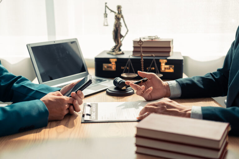 Businesses and lawyers are discussing contract documents and legal entities in law firms and are examining legal documents with the hammer and scales of justice. which is a symbol of the law