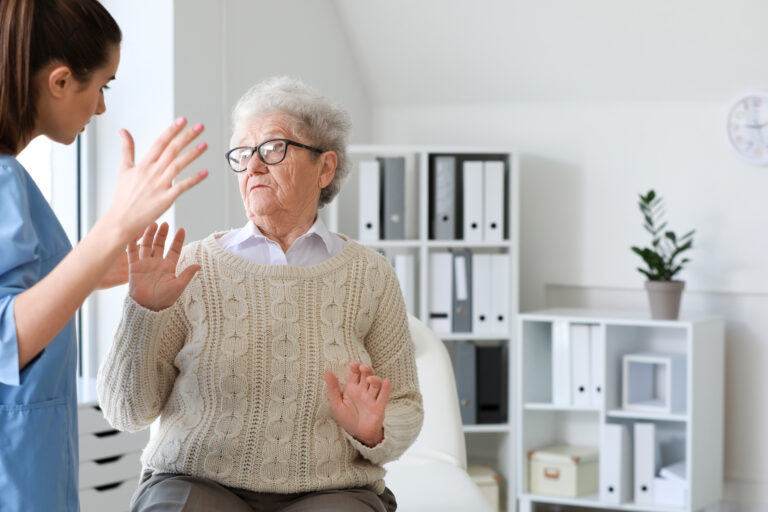 Medical worker mistreating senior woman in nursing home